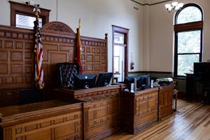 Interior view of an American courthouse in Kirksville, Missouri, featuring a judge's desk and flags.